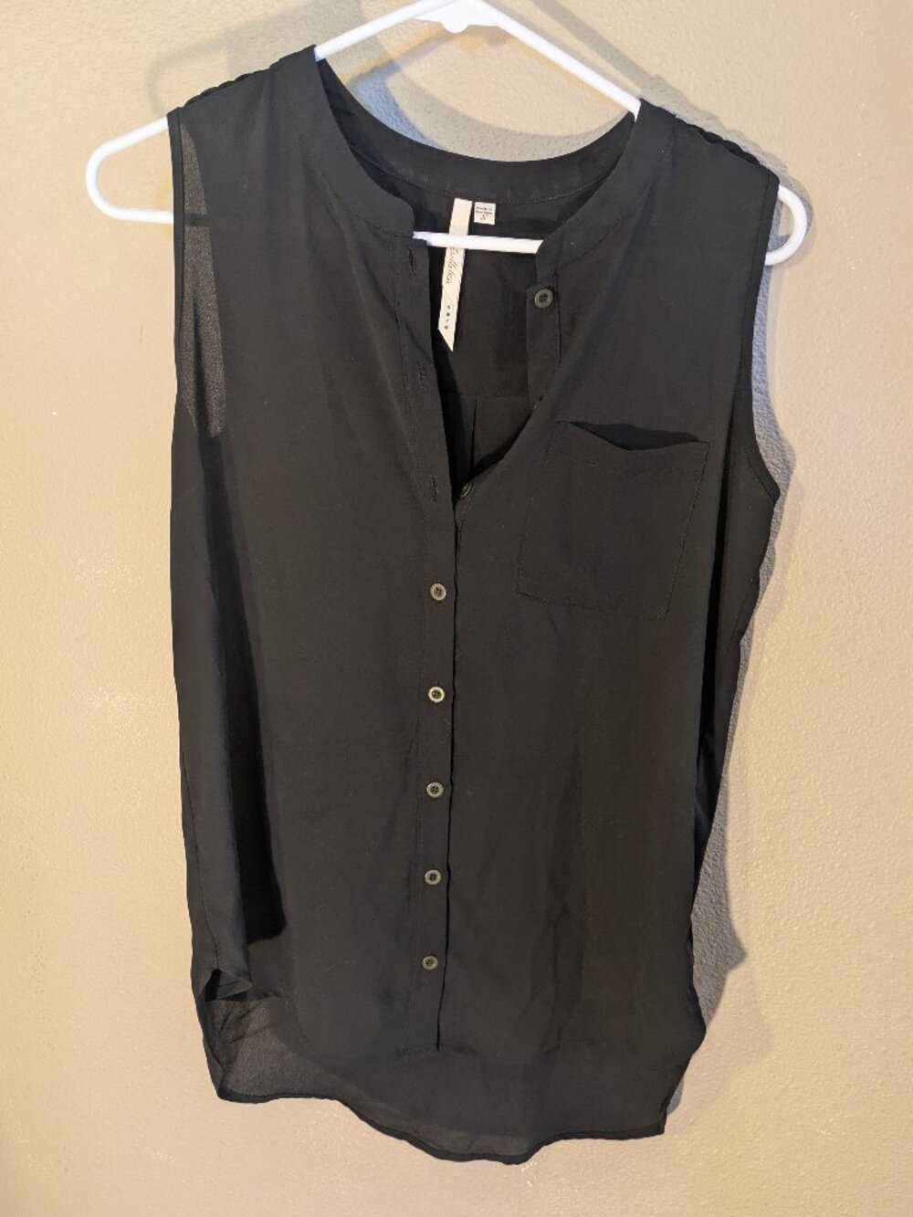 Black sleeveless button-up blouse